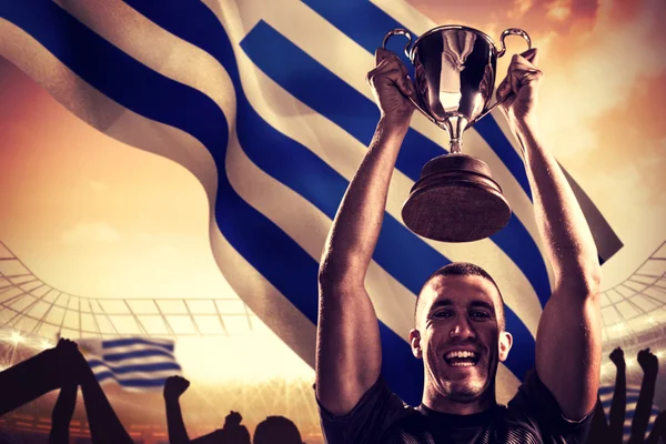 Successful rugby player holding trophy — Stock Photo, Image