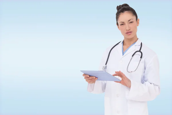 Focused doctor using her tablet pc — Stock Photo, Image