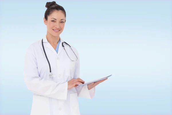 Happy doctor using her tablet pc — Stock Photo, Image