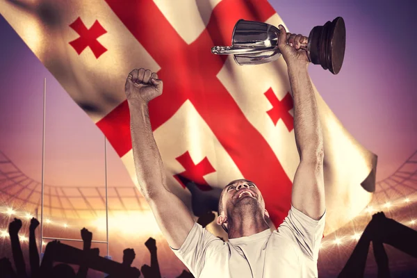 Happy rugby spelare anläggning trophy — Stockfoto