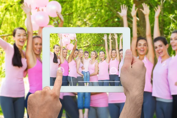 Composite image of hand holding tablet pc — Stock Photo, Image