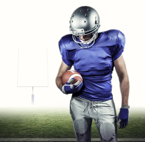 American football player looking down — Stock Photo, Image