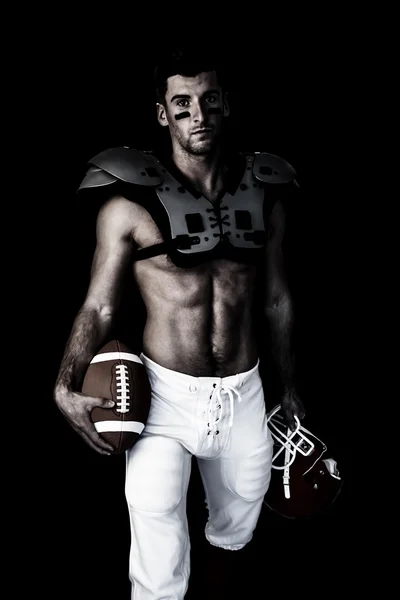 Rugby player holding ball and helmet — Stock Photo, Image