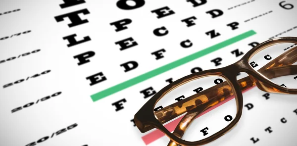 Reading glasses against eye test — Stock Photo, Image