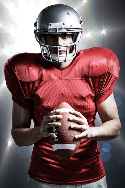 Confident American football player holding ball — Stock Photo, Image