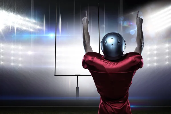 American football player with arms raised — Stock Photo, Image