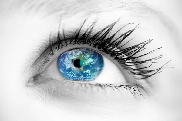 Blue eye on grey face against earth — Stock Photo, Image