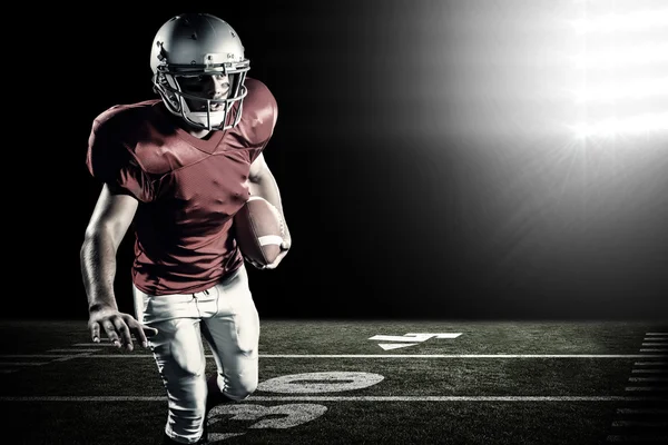 Sportsman running while playing American football — Stock Photo, Image