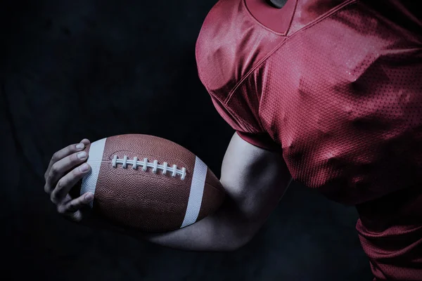 Cropped american football player holding ball — Stock Photo, Image
