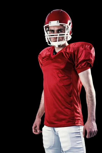 Un jugador de fútbol americano serio tomando su casco — Foto de Stock