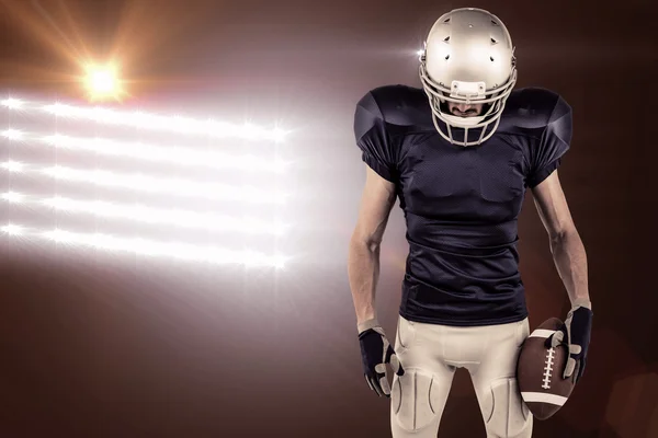 American football player looking down — Stock Photo, Image