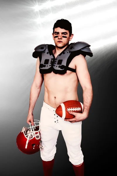 American football player holding a ball and helmet — Stock Photo, Image