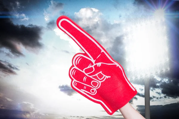 American football player holding supporter foam hand — Stock Photo, Image