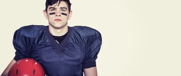 American football player holding a helmet — Stock Photo, Image