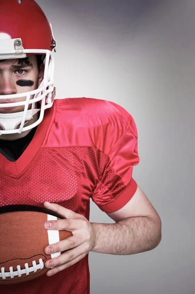 American football player holding a ball — Stock Photo, Image