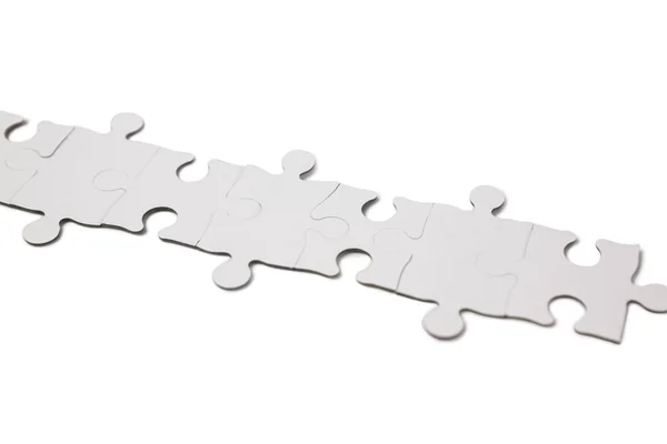 Overhead of white jigsaw — Stock Photo, Image