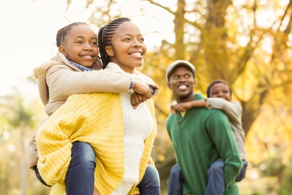 Portrait of a young smiling family in piggyback — Stock Photo, Image