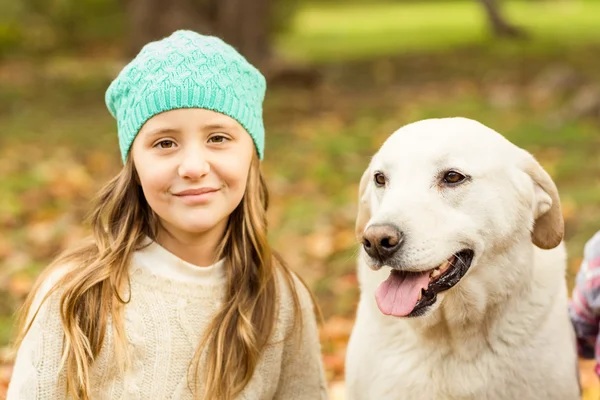 Smiling young girl with her dog — Stock Photo, Image