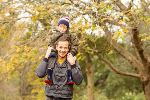 Jonge vader opheffing van zijn zoontje in park — Stockfoto