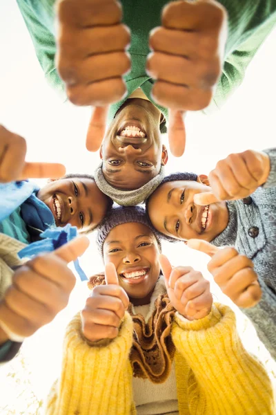 Young family doing a head circles with thumbs up — Stock Photo, Image