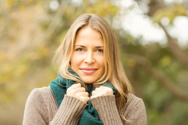 Smiling woman holding her scarf — Stock Photo, Image