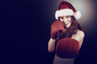 Festive redhead punching with boxing gloves clipart