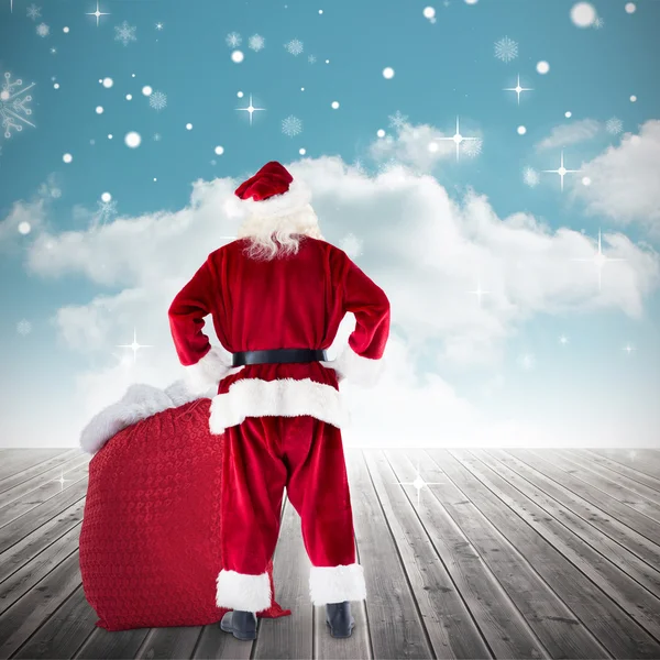 Composite image of santa with sack of gifts — Stock Photo, Image