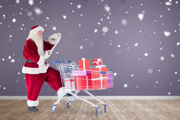 Imagen compuesta de santa entrega de regalos desde el carrito — Foto de Stock