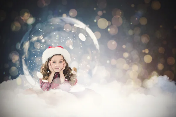 Imagen compuesta de niño festivo en bola de nieve — Foto de Stock