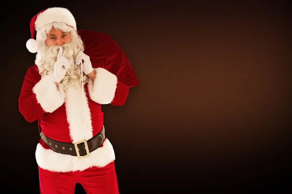 Santa segurando saco e manter um segredo — Fotografia de Stock