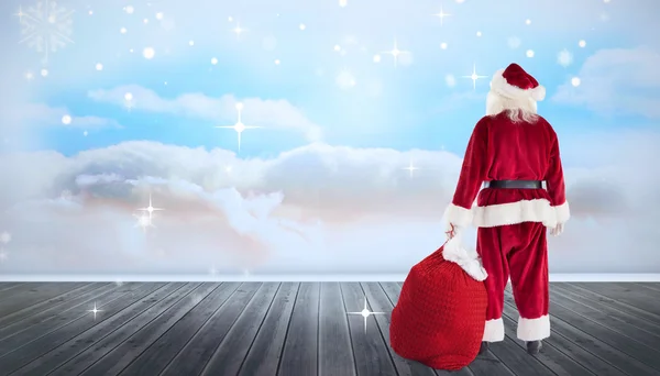 Immagine composita di Babbo Natale con sacco di regali — Foto Stock