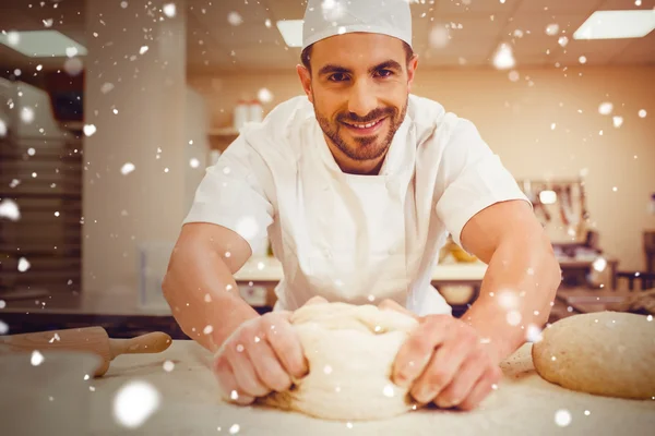 Baker kneading dough at a counter — Stock Photo, Image