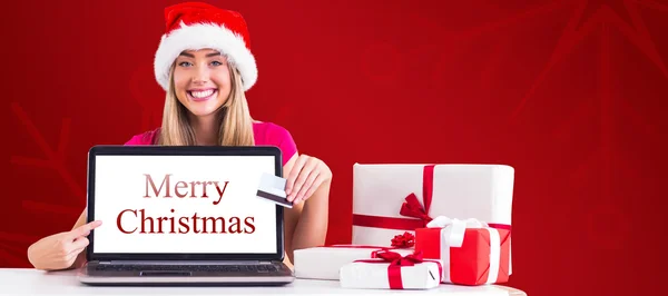 Festive blonde shopping online with laptop — Stock Photo, Image