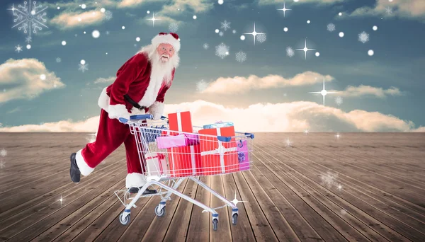 Santa empurrando carrinho de compras — Fotografia de Stock