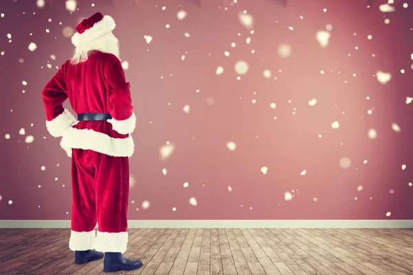 Composite image of santa with hands on hips — Stock Photo, Image