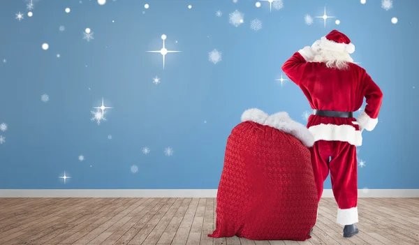 Imagen compuesta de santa con saco de regalos —  Fotos de Stock