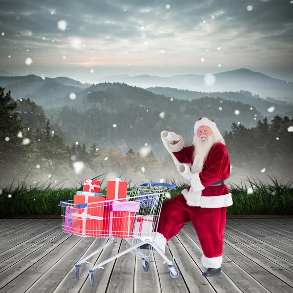 Santa delivering gifts from cart — Stock Photo, Image