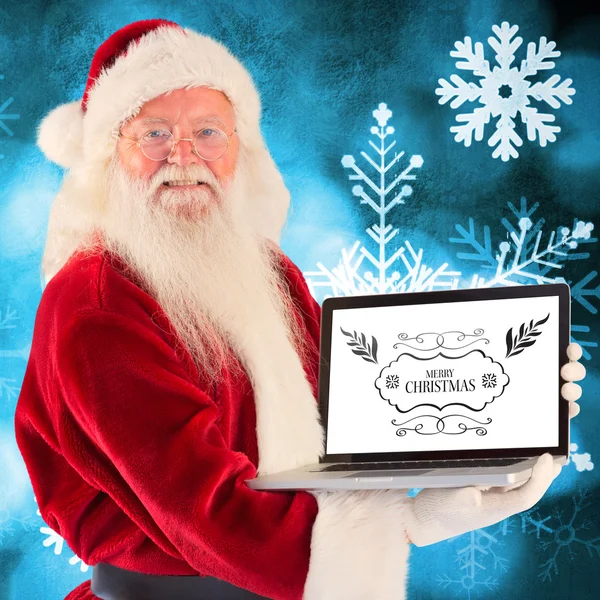 Santa Claus presenterar en laptop — Stockfoto