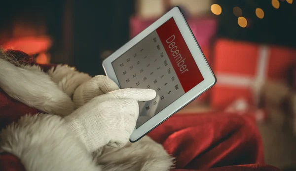 Santa claus touching tablet pc — Stock Photo, Image