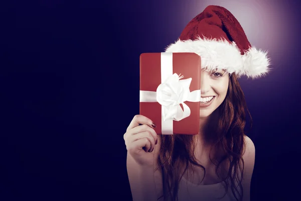 Festive redhead holding a gift — Stock Photo, Image