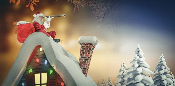 Santa sitting on roof of cottage — Stock Photo, Image