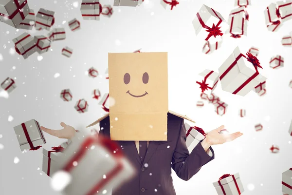 Businessman shrugging with box on head — Stock Photo, Image