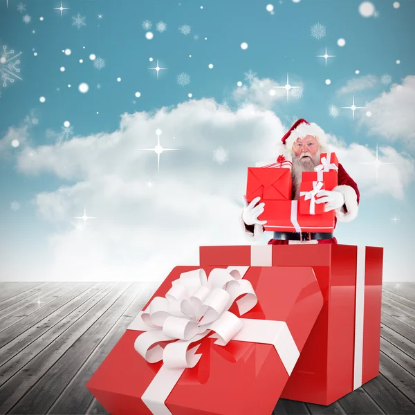 Santa standing in large gift — Stock Photo, Image