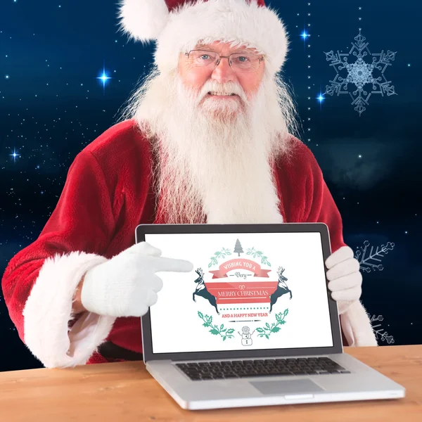 Happy santa showing laptop screen — Stock Photo, Image