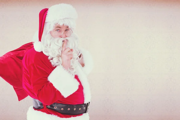 Santa guardando un secreto y sosteniendo su saco — Foto de Stock