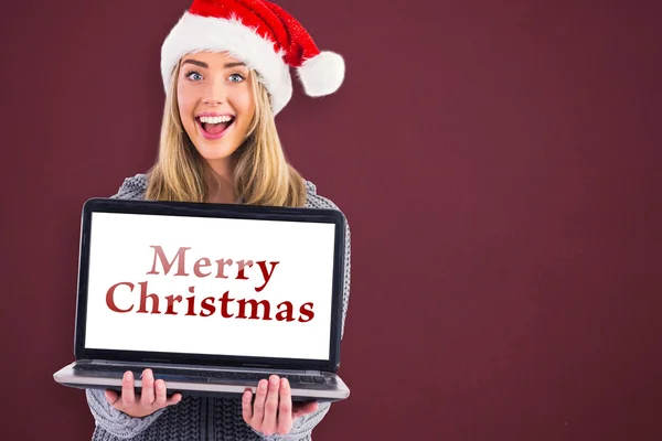 Festive blonde holding a laptop — Stock Photo, Image