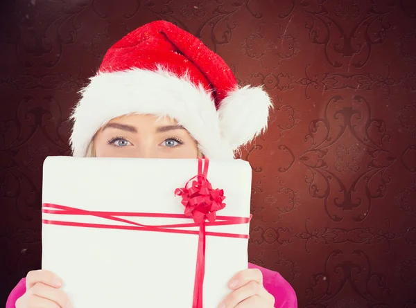 Festive blonde holding christmas gift — Stock Photo, Image