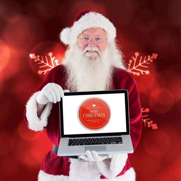 Santa Claus präsentiert einen Laptop — Stockfoto