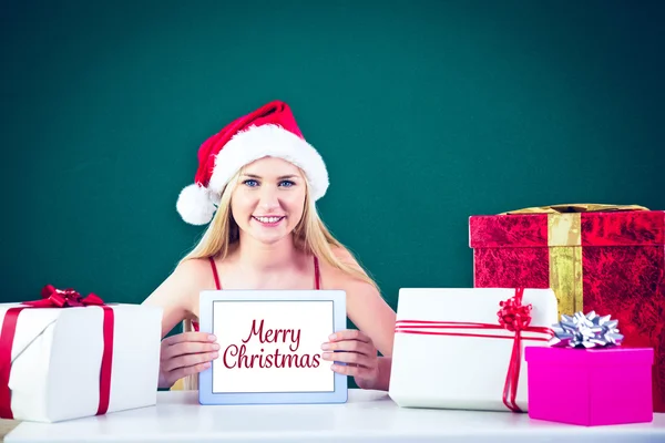 Festive blonde shopping online with tablet pc — Stock Photo, Image