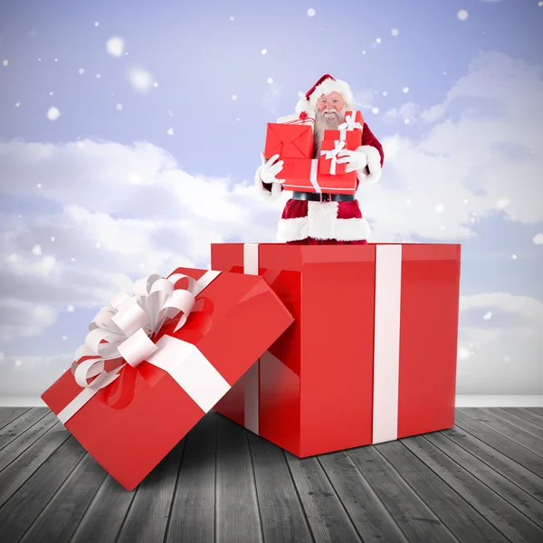 Santa standing in large gift — Stock Photo, Image